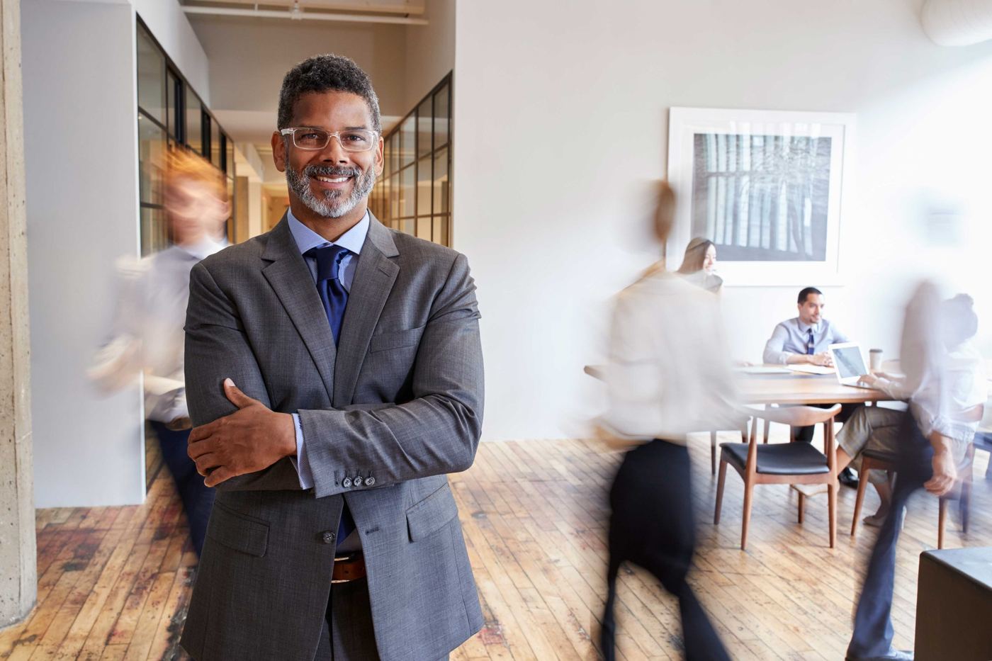 Business owner standing in a busy modern office